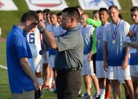 Air Force Head Coach Maj. Jeremiah Kirschman, left, is awarded a championship medal by Army Col. Kyle Reed, Garrison Commander of Fort Bragg, at Hedrick Stadium on Fort Bragg, N.C.