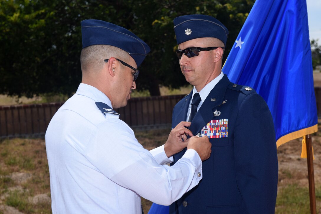 Col. Curtis Hernandez, 30th Operations Group commander, presents the meritorious service medal to Lt. Col. Max Coberly, 30th Range Management Squadron commander, at Vandenberg Air Force Base, Calif., on July 10, 2018. Coberly was presented the medal shortly after the inactivation of the 30th RMS. (U.S. Air Force photo by Tech. Sgt. Jim Araos/Released)