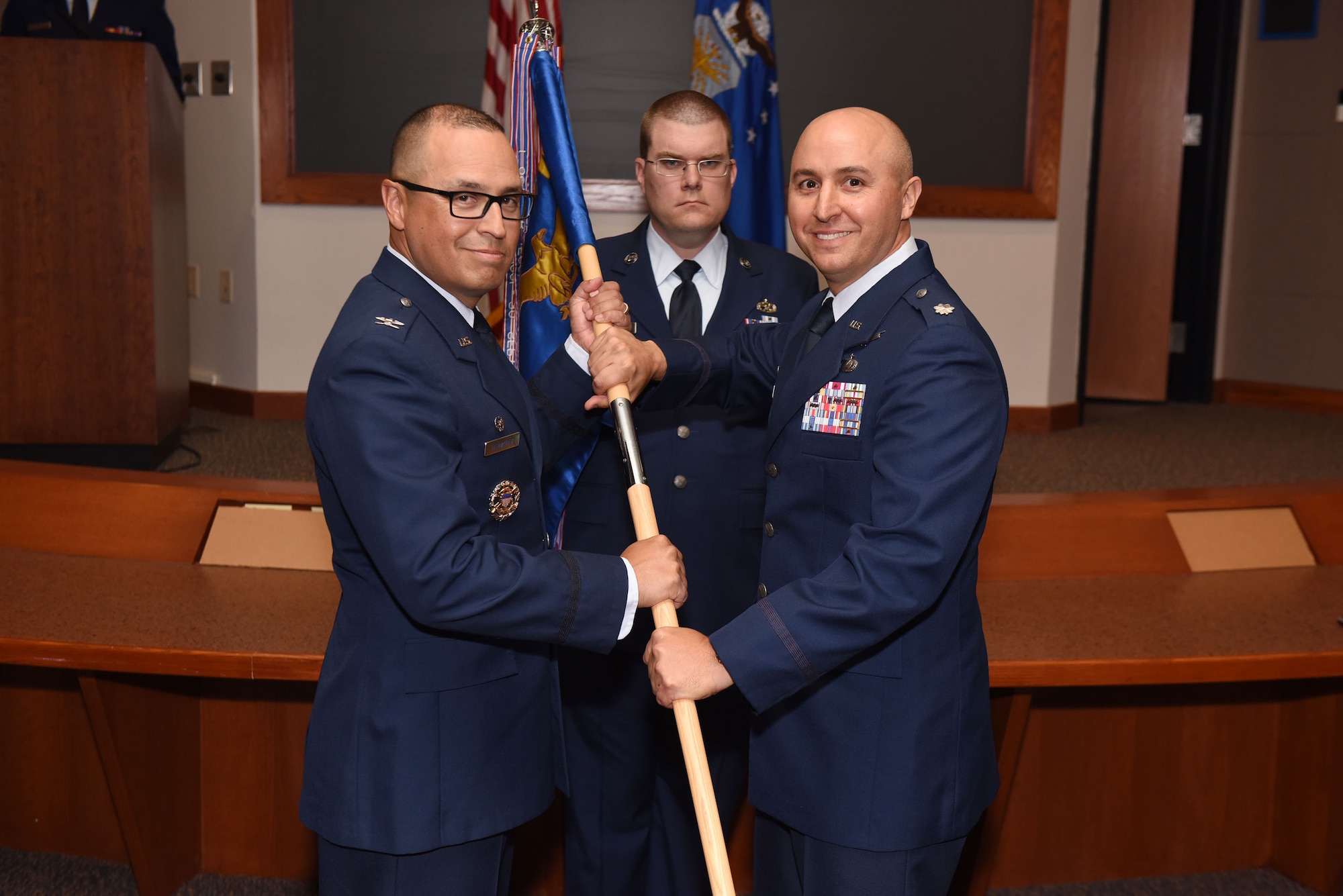 Col. Curtis Hernandez, 30th Operations Group commander, and Lt. Col. Max Coberly, 30th Range Management Squadron commander, inactivate the 30th RMS and merge with the 2nd Range Operations Squadron at Vandenberg Air Force Base, Calif., on July 10, 2018. The reorganization allows all range mission assurance operations to be conducted under a single chain of command. (U.S. Air Force photo by Tech. Sgt. Jim Araos/Released)