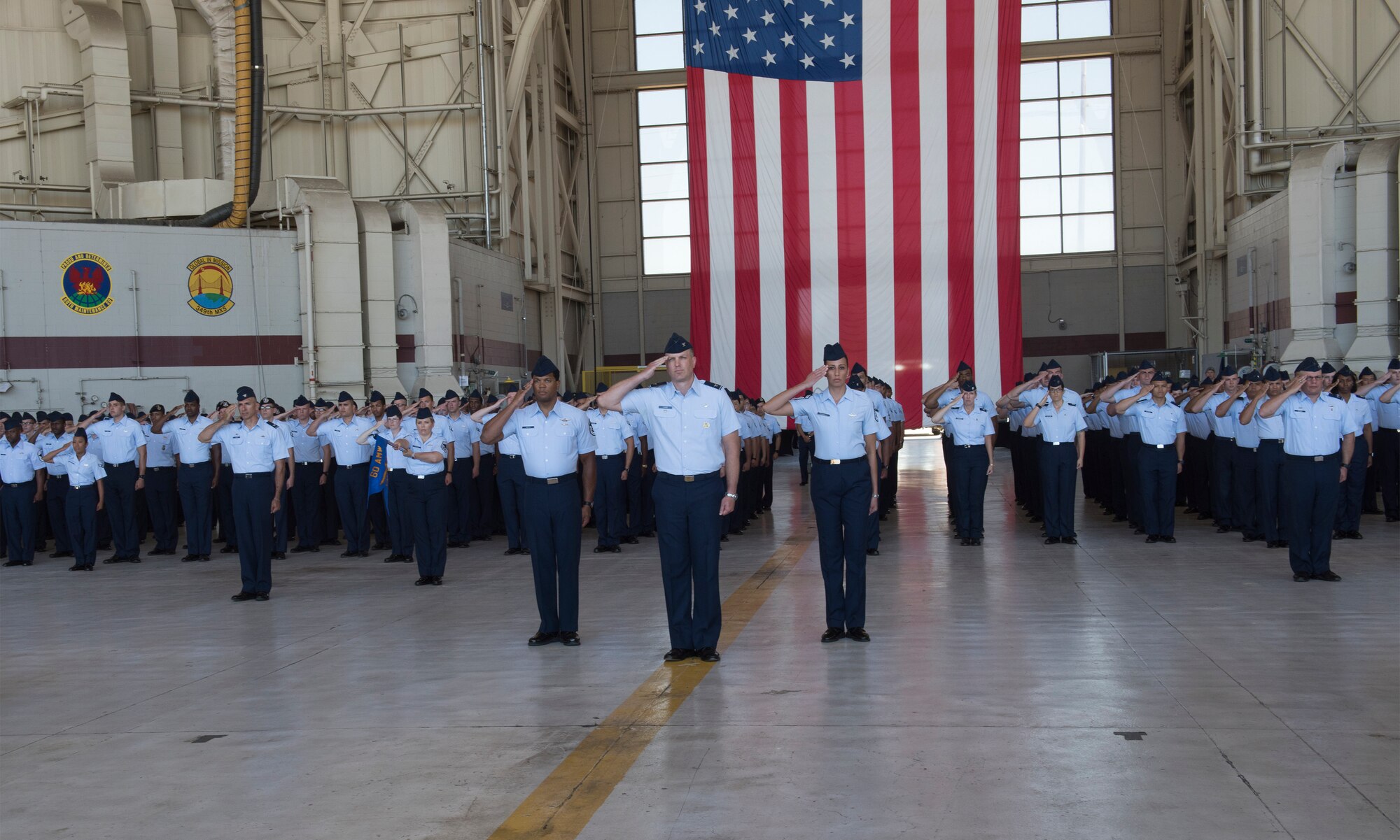 U.S. Air Force Airman render a final salute to Col. John Klein, commander, 60th Air Mobility Wing during a change of command ceremony, July 10, 2018, Travis Air Force Base, Calif.  Klein relinquished command of Air Mobility Command's largest wing to Col. Ethan Griffin. (U.S. Air Force Photo by Heide Couch)