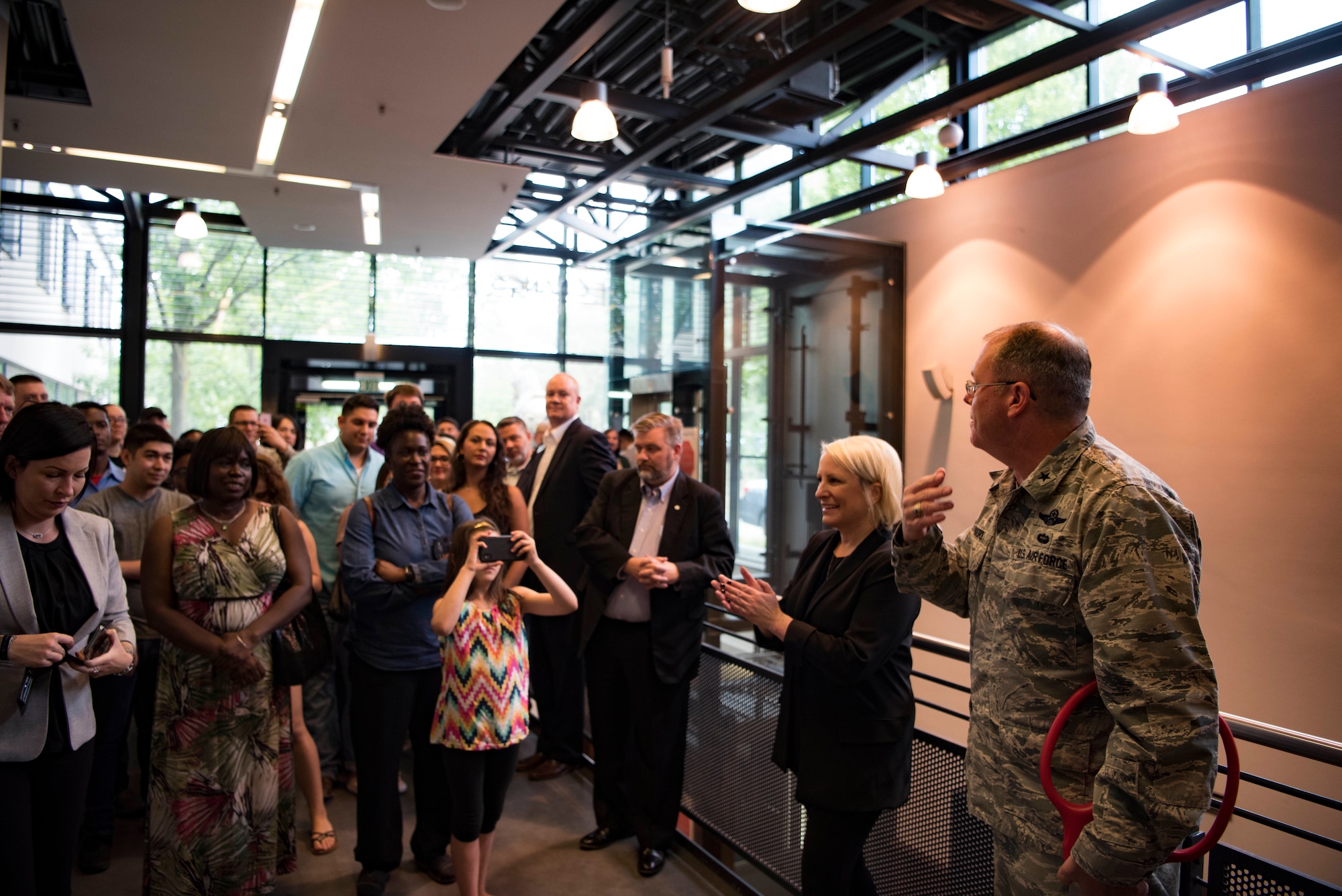 U.S. Air Force Brig. Gen. Richard G. Moore, 86th Airlift Wing commander, welcomes 2the first customers to enter P.F. Chang’s shortly after taking part in the red-ribbon cutting for the new restaurant on Ramstein Air Base, Germany, June 25, 2018. There are a variety of popular dishes offered that customers will recognize from P.F. Chang’s stateside restaurants.