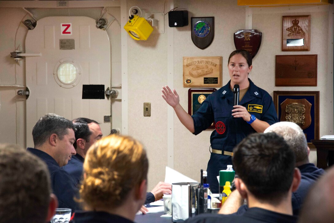 A Navy instructor briefs sailors before conducting training.