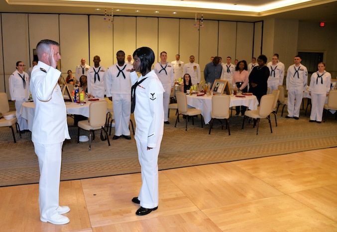 Navy Petty Officer 3rd Class Lasonya Lowe, center, a hospital corpsman serving at Naval Health Clinic Charleston, swears the Oath of Enlistment as she reenlists June 16, 2018, during NHCC’s Corpsman Ball at the Charleston Club. Lt. Terry Starkey, left, head of NHCC’s Occupational Medicine, served as Lowe’s reenlisting officer.
