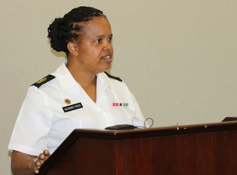 The Sisters in Arms Program at U.S. Army Central holds a general session in the Yellow Ribbon of Patton Hall on 6 July.  Sgt. Maj. Kimberly McGhaney-Reed, USARCENT G36 Protection, introduces the guest speaker. Sisters in Arms is a professional forum in which female service members, DA Civilians and contractors empower each other to be successful through leadership, education, training and mentoring.