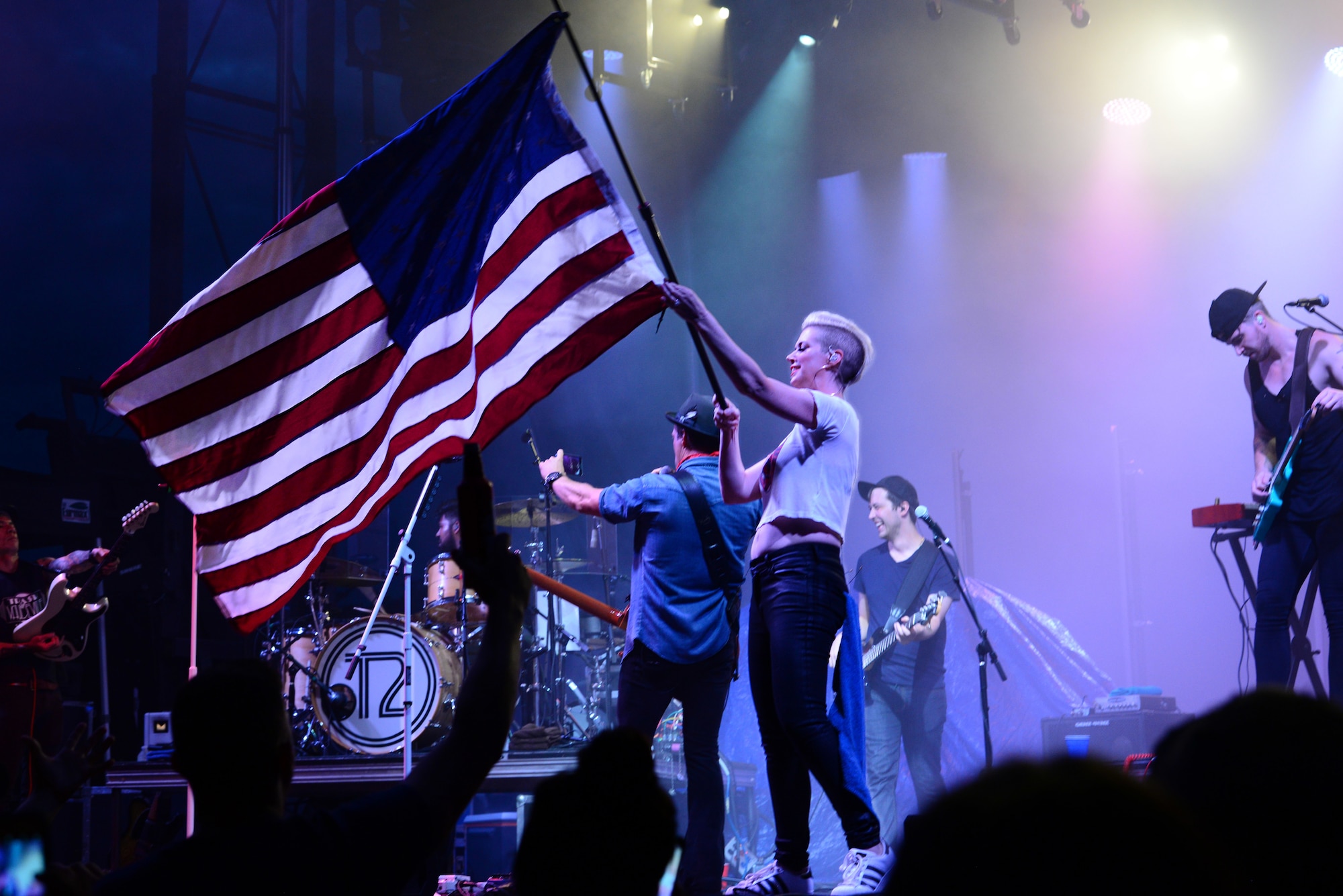 Shawna Thompson, lead singer for the American country music group Thompson Square, waves an American Flag during their performance July 6, 2018, on Columbus Air Force Base, Mississippi. Patriot Fest 2018 featured a concert with Thompson Square and Easton Corbin along with food vendors and children’s activities. (U.S. Air Force photo by Airman 1st Class Beaux Hebert)