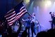 Shawna Thompson, lead singer for the American country music group Thompson Square, waves an American Flag during their performance July 6, 2018, on Columbus Air Force Base, Mississippi. Patriot Fest 2018 featured a concert with Thompson Square and Easton Corbin along with food vendors and children’s activities. (U.S. Air Force photo by Airman 1st Class Beaux Hebert)