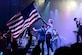 Shawna Thompson, lead singer for the American country music group Thompson Square, waves an American Flag during their performance July 6, 2018, on Columbus Air Force Base, Mississippi. Patriot Fest 2018 featured a concert with Thompson Square and Easton Corbin along with food vendors and children’s activities. (U.S. Air Force photo by Airman 1st Class Beaux Hebert)