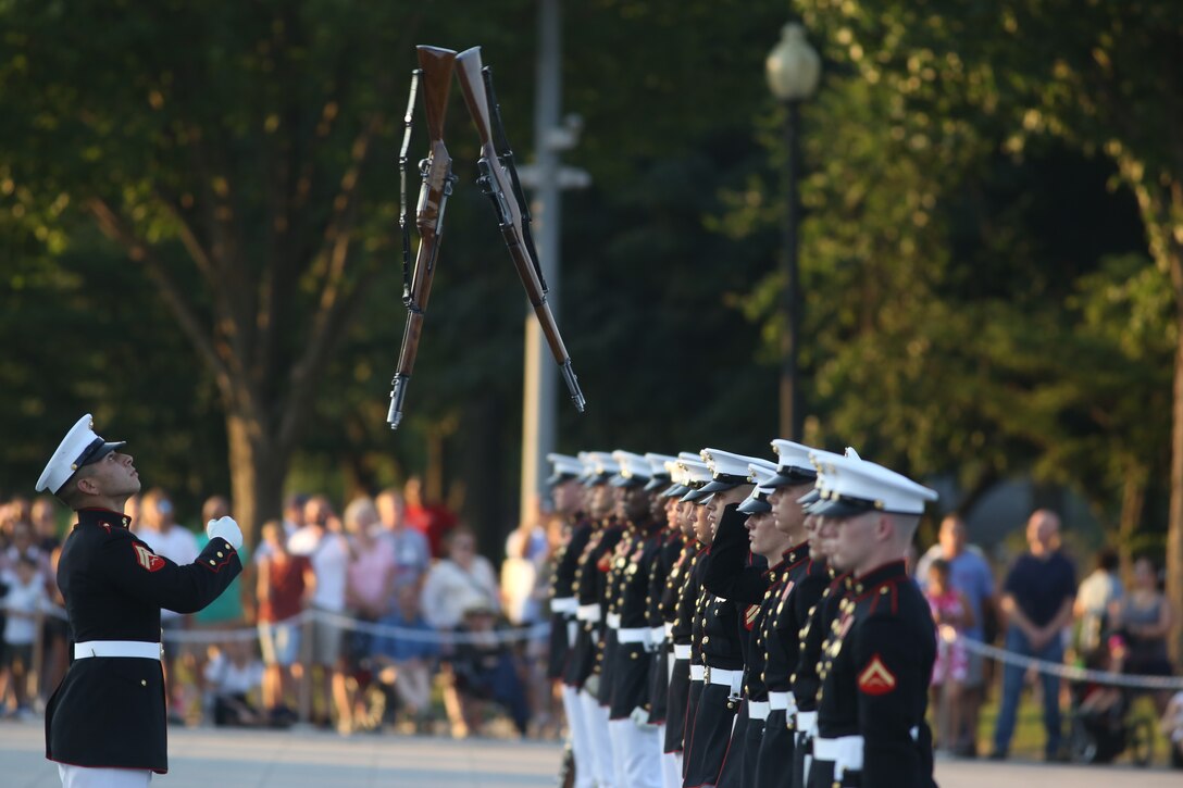 Corporal Christopher Ochoa, rifle inspector, U.S. Marine Corps Silent Drill Platoon, prepares to catch a rifle during a Tuesday Sunset Parade at the Lincoln Memorial, Washington D.C., July 10, 2018. The guest of honor for the parade was the former Vice President of the U.S., Joe Biden, and the hosting official was the Staff Judge Advocate to the Commandant of the Marine Corps, Maj. Gen. John R. Ewers Jr. (Official Marine Corps photo by LCpl Bourgeois/Released)
