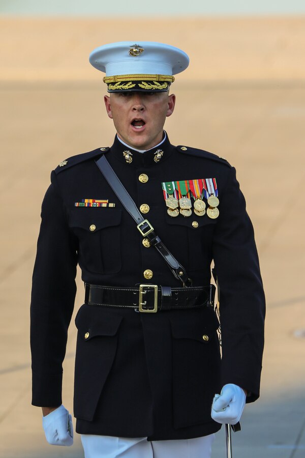 Major Russell Fluker, parade adjutant, Marine Barracks Washington D.C., calls a command during a Tuesday Sunset Parade at the Lincoln Memorial, Washington D.C., July 10, 2018. The guest of honor for the parade was the former Vice President of the U.S., Joe Biden, and the hosting official was the Staff Judge Advocate to the Commandant of the Marine Corps, Maj. Gen. John R. Ewers Jr. (Official Marine Corps photo by Cpl. Damon Mclean/Released)