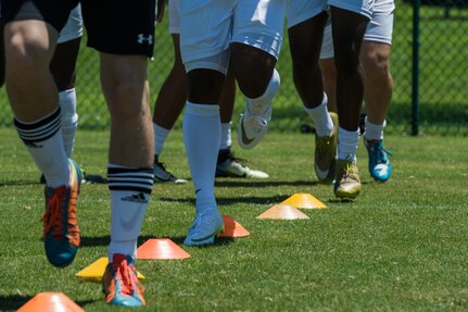 Members of the Joint Base Langley-Eustis Soccer Club warm up before a scrimmage against the Lionsbridge Football Club at Riverview Park, Newport News, Virginia, July 8, 2018.