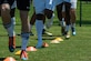 Members of the Joint Base Langley-Eustis Soccer Club warm up before a scrimmage against the Lionsbridge Football Club at Riverview Park, Newport News, Virginia, July 8, 2018.