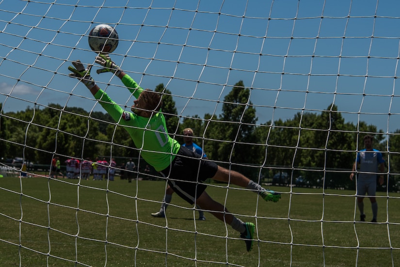 Luke Messick, Lionsbridge Football Club goalkeeper, practices diving for balls before a scrimmage against the Joint Base Langley-Eustis Soccer Club at Riverview Park, Newport News, Virginia, July 8, 2018.
