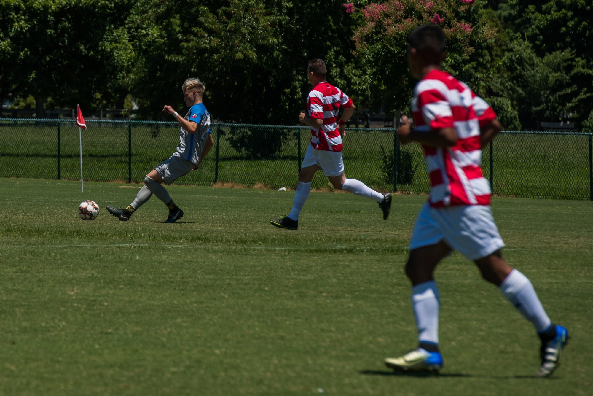 Felix Kollmannthaler, Lionsbridge Football Club midfielder, dribbles the ball away from U.S. Army Spc. Steven Estrada, Joint Base Langley-Eustis Soccer Club striker, during a scrimmage at Riverview Park, Newport News, Virginia, July 8, 2018.