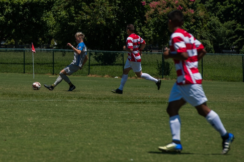 Felix Kollmannthaler, Lionsbridge Football Club midfielder, dribbles the ball away from U.S. Army Spc. Steven Estrada, Joint Base Langley-Eustis Soccer Club striker, during a scrimmage at Riverview Park, Newport News, Virginia, July 8, 2018.