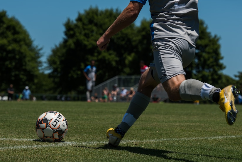 A member of the Lionsbridge Football Club kicks a corner kick during a scrimmage against the Joint Base Langley- Eustis Soccer Club at Riverview Park, Newport News, Virginia, July 8, 2018.