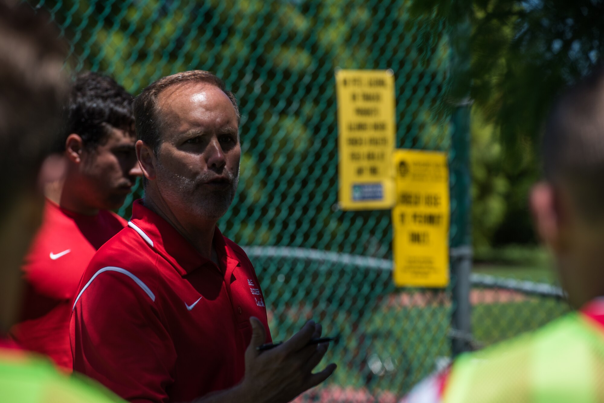Hermann Groombridge, Joint Base Langley-Eustis Soccer Club coach, speaks with the team during the half at Riverview Park, Newport News, Virginia, July 8, 2018.