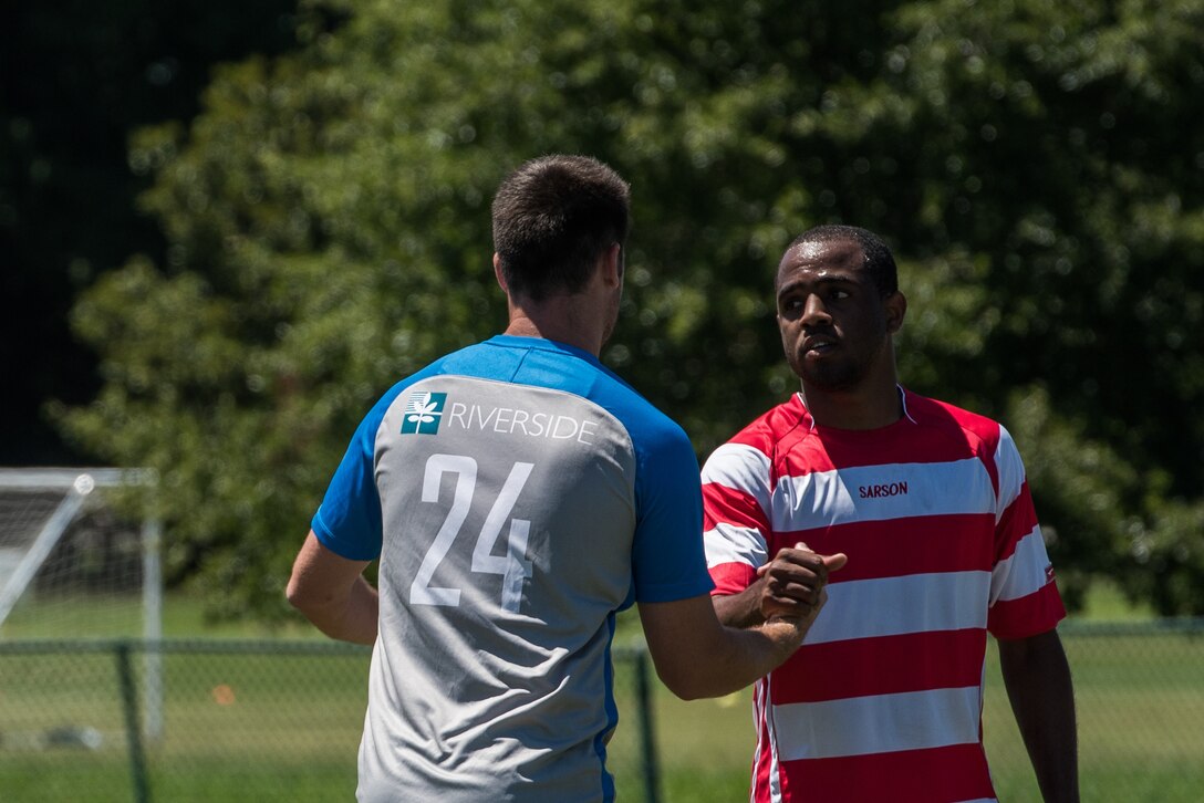 Lee Williams, Lionsbridge Football Club defender, and U.S. Air Force Airman 1st Class Jairzinho Burke, Joint Base Langley-Eustis Soccer Club midfielder, commend each other on a good game after a scrimmage at Riverview Park, Newport News, Virginia, July 8, 2018.