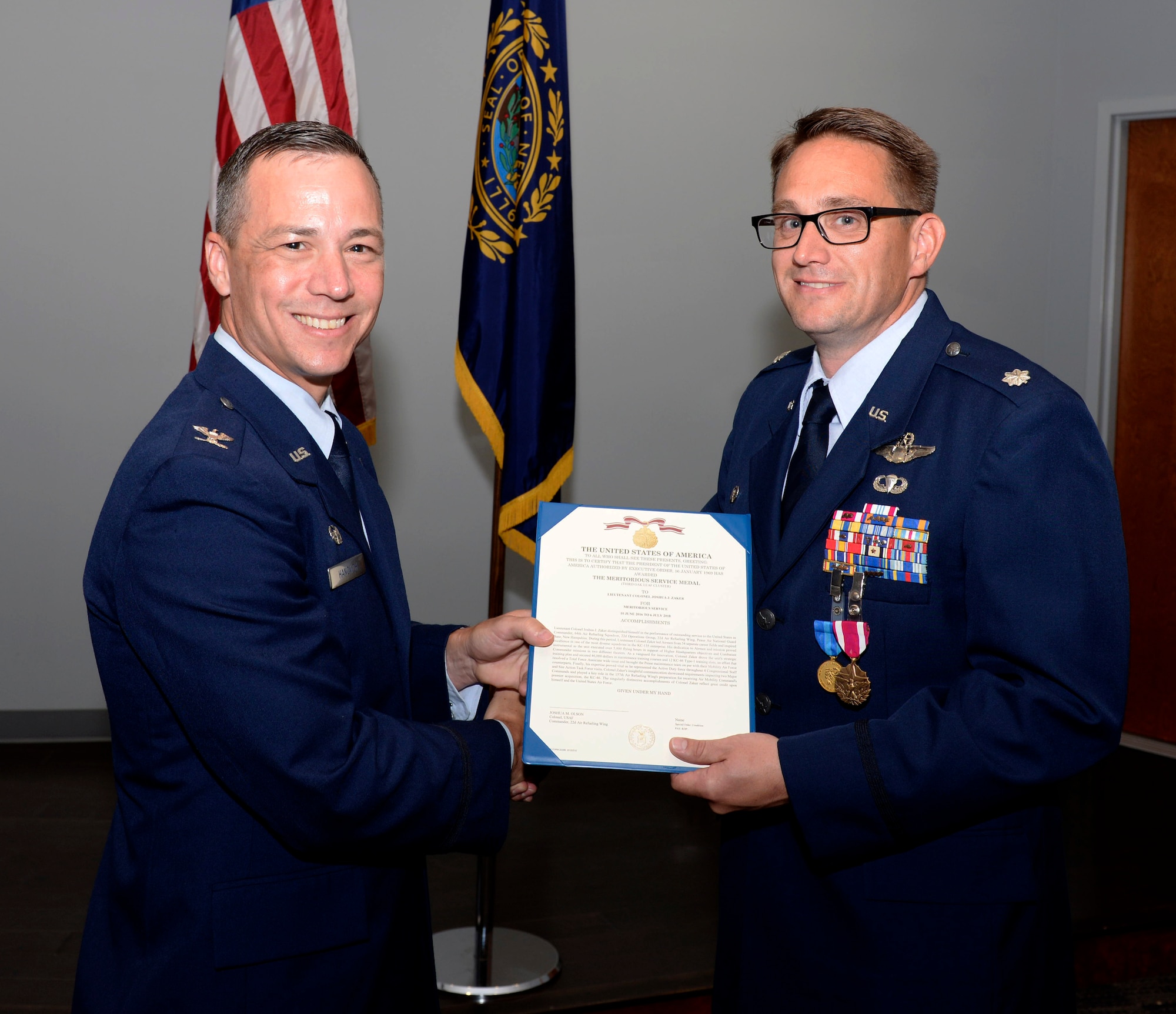 Lt. Col. Joshua J. Zaker, commander of the 64th Air Refueling Squadron, receives a Meritorious Service Medal certificate from Col. Robert L. Hanovich JR, commander of the 22nd Operations Group at McConnell Air Force Base, Kan. during a ceremony on July 6, 2018 at Pease Air National Guard Base, N.H. Zaker relinquished command of the 64th ARS after more than three years as the commander. (N.H. Air National Guard photo by Staff Sgt. Kayla White)