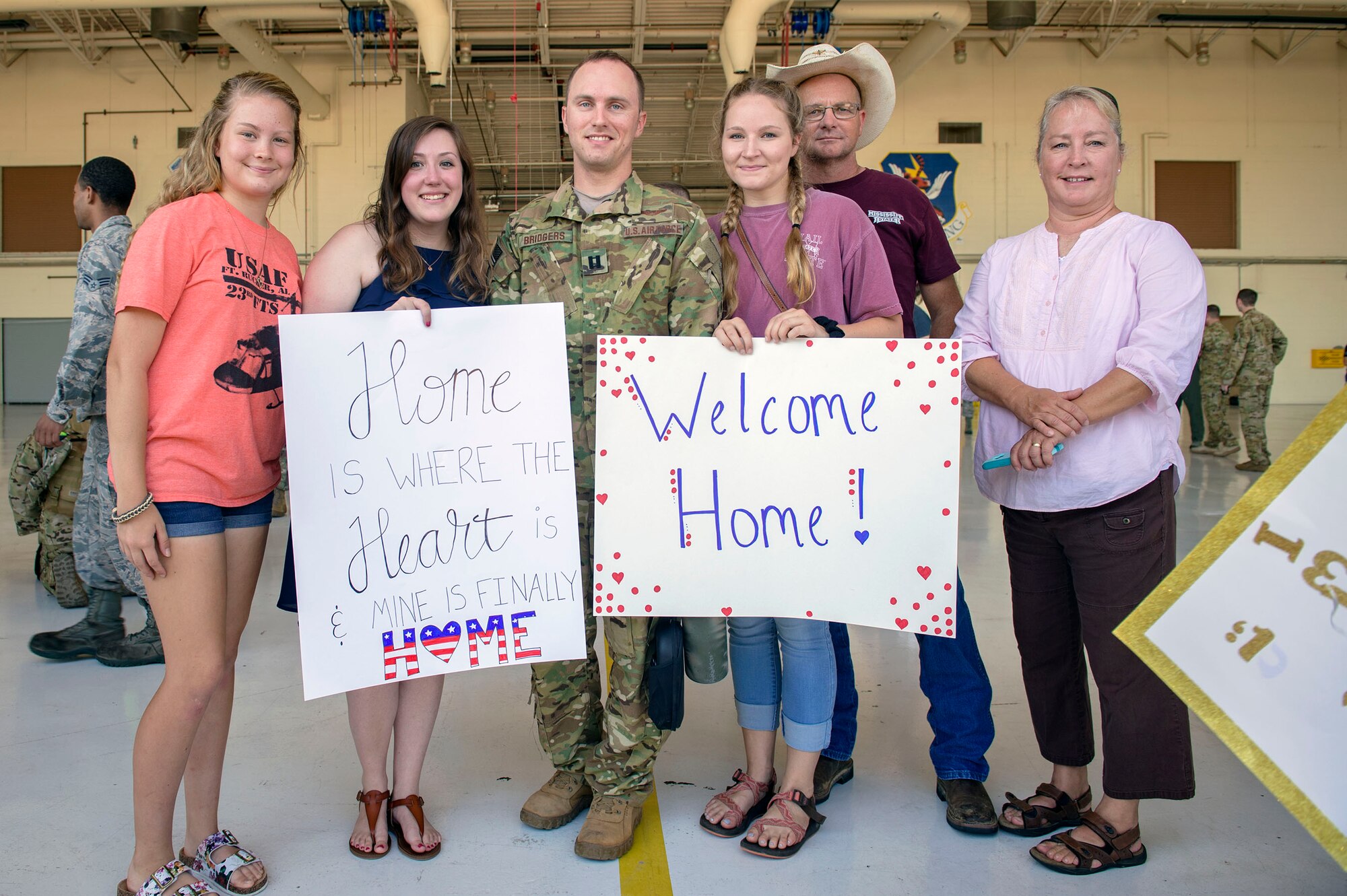 cCapt. Dalton Bridgers, 41st Rescue Squadron (RQS) HH-60G Pave Hawk pilot, reunites with his family during a redeployment ceremony, July 10, 2018, at Moody Air Force Base, Ga. While deployed, the 41st RQS and 41st Helicopter Maintenance Unit provided combat search and rescue capabilities and maintenance operations in support of Combined Joint Task Force-Horn of Africa. (U.S Air Force photo by Senior Airman Greg Nash)