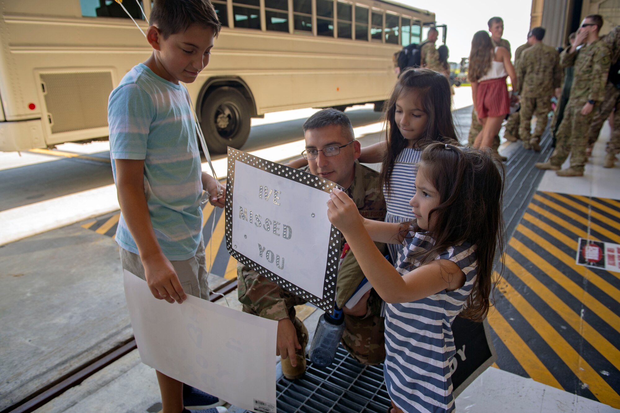 Senior Master Sgt. Alejandro Munoz, 723d Aircraft Maintenance Squadron superintendent, reunites with his family during a 41st Rescue Squadron redeployment ceremony, July 10, 2018, at Moody Air Force Base, Ga.  While deployed, the 41st RQS and 41st Helicopter Maintenance Unit provided combat search and rescue capabilities and maintenance operations in support of Combined Joint Task Force-Horn of Africa. (U.S Air Force photo by Senior Airman Greg Nash)