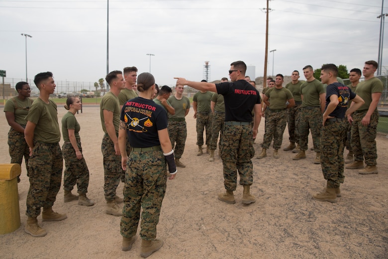 U.S. Marine Corps Sgt. Jesse Clay, Sgt. Jenna Cauble, and Sgt. Alberto Deloreyes, instructors with Corporals Course class 6-18, Marine Corps Air Station (MCAS) Yuma, Ariz., give a brief prior to conducting an obstacle course on MCAS Yuma, Ariz., June 15, 2018. Marines, Sailors and Airmen attended the two week course focused on Marine Corps leadership, standards, professional development and physical fitness. (U.S. Marine Corps photo by Sgt. Allison Lotz)
