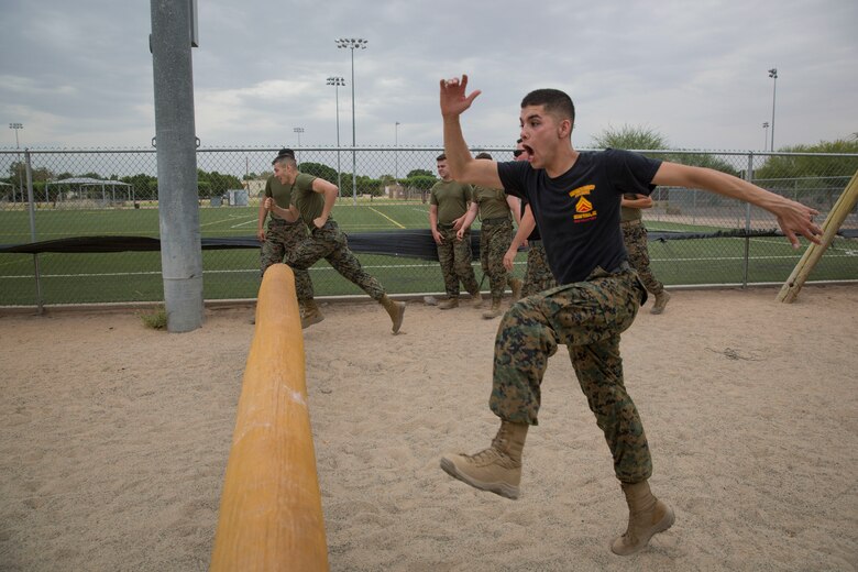 U.S. Marine Corps Sgt. Alberto Deloreyes an instructor with Corporals Course class 6-18, Marine Corps Air Station (MCAS) Yuma, Ariz., motivates students as they conduct an obstacle course on MCAS Yuma, Ariz., June 15, 2018. Marines, Sailors and Airmen attended the two week course focused on Marine Corps leadership, standards, professional development and physical fitness. (U.S. Marine Corps photo by Sgt. Allison Lotz)