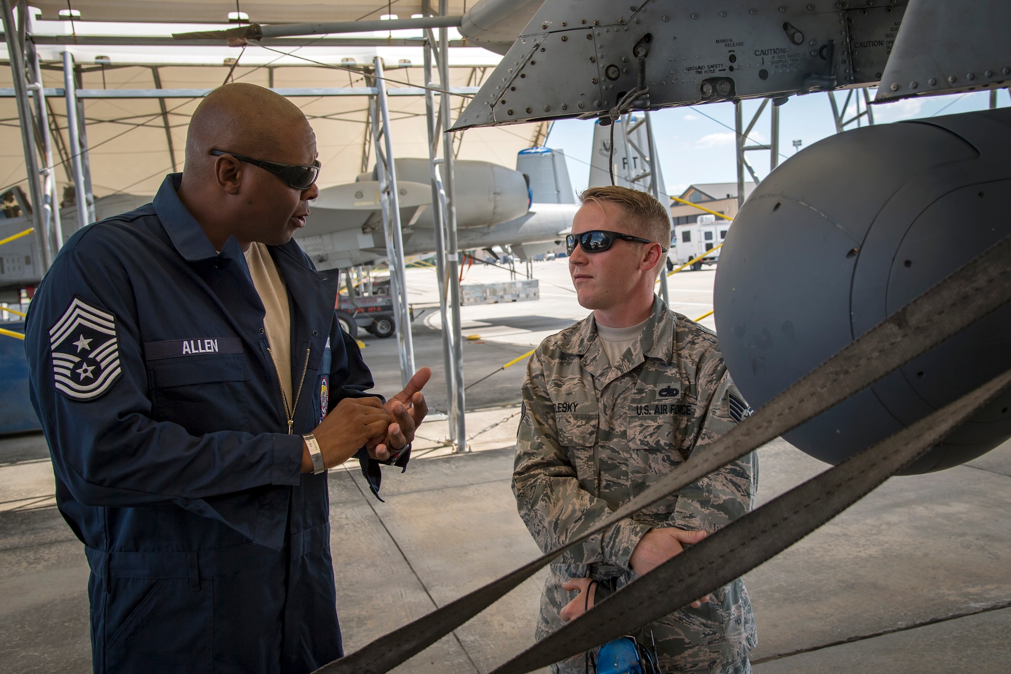 Chief Master Sgt. James Allen, 23d Wing command chief, left, speaks with Staff Sgt. Eric Belesky, 23d Aircraft Maintenance Squadron (AMXS) avionics technician, during an immersion tour, July 10, 2018, at Moody Air Force Base, Ga. Allen toured the 23d AMXS to build rapport and experience the day to day operations of maintenance Airmen. Throughout his visit, Allen was able to speak with Airmen and hear their opinions and ideas behind the continued success of the AMXS. (U.S. Air Force photo by Airman 1st Class Eugene Oliver)