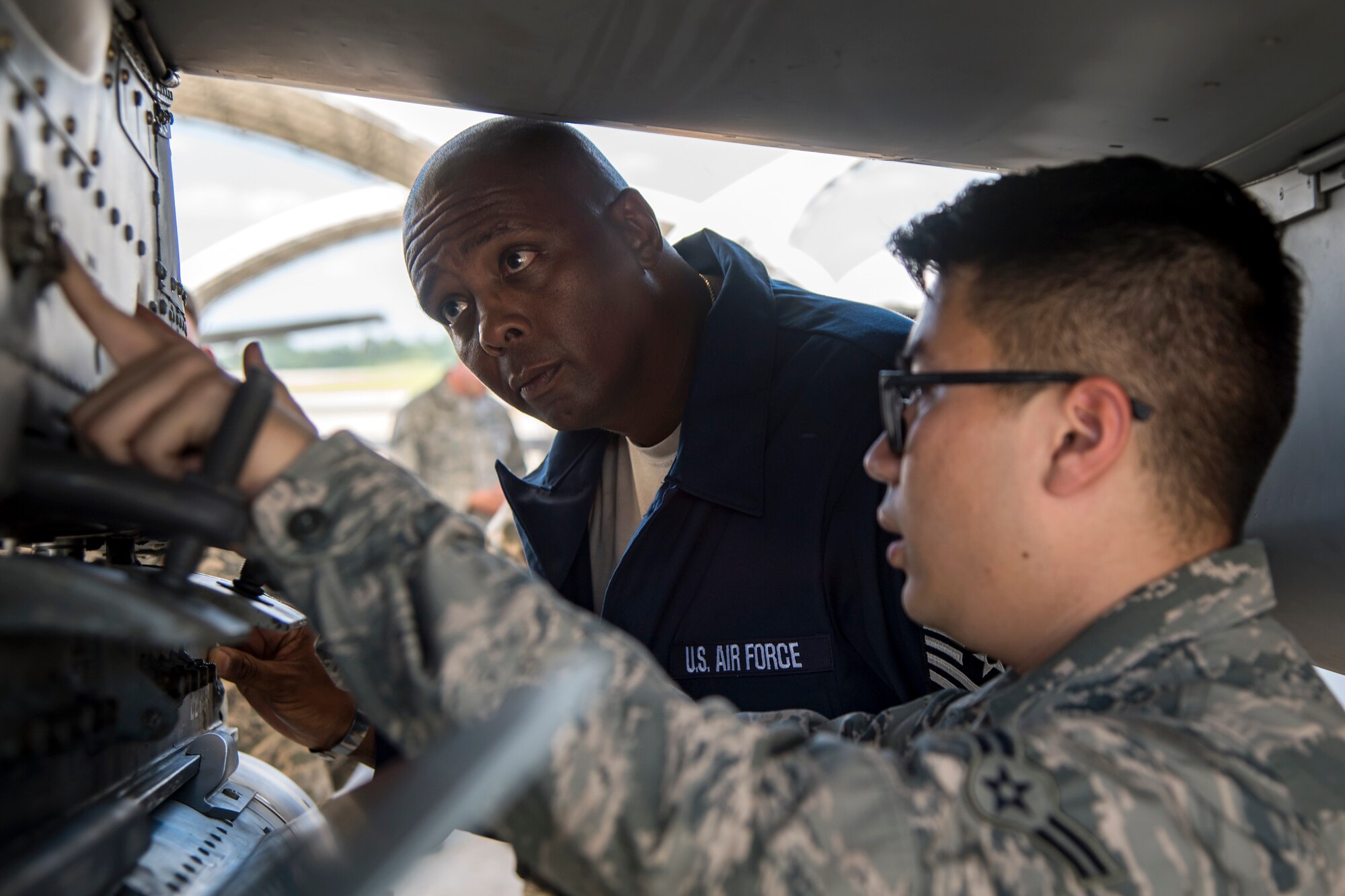 Airman First Class Tommy Nguyen, 23d Aircraft Maintenance Squadron (AMXS) crew chief, explains the functions of an A-10C Thunderbolt II internal component to Chief Master Sgt. James Allen, 23d Wing command chief, during an immersion tour, July 10, 2018, at Moody Air Force Base, Ga. Allen toured the 23d AMXS to build rapport and experience the day to day operations of maintenance Airmen.  Throughout his visit, Allen was able to speak with Airmen and hear their opinions and ideas behind the continued success of the AMXS. (U.S. Air Force photo by Airman 1st Class Eugene Oliver)