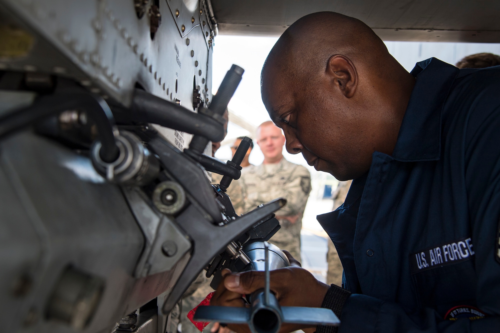 Chief Master Sgt. James Allen, 23d Wing command chief, attempts to install a BDU-33 practice bomb onto an A-10C Thunderbolt II during an immersion tour, July 10, 2018, at Moody Air Force Base, Ga. Allen toured the 23d Aircraft Maintenance Squadron (AMXS) to build rapport and experience the day to day operations of maintenance Airmen. Throughout his visit, Allen was able to speak with Airmen and hear their opinions and ideas behind the continued success of the AMXS. (U.S. Air Force photo by Airman 1st Class Eugene Oliver)