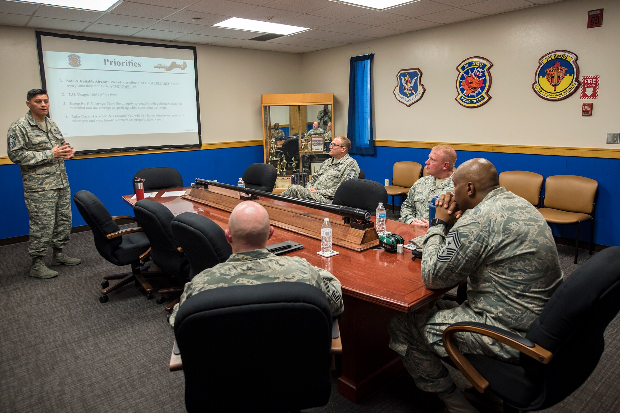 Senior Master Sgt. Raul Lopez, 74th Aircraft Maintenance Unit superintendent, left, briefs Chief Master Sgt. James Allen, 23d Wing command chief, far right, during an immersion tour, July 10, 2018, at Moody Air Force Base, Ga. Allen toured the 23d Aircraft Maintenance Squadron (AMXS) to build rapport and experience the day to day operations of maintenance Airmen.  Throughout his visit, Allen was able to speak with Airmen and hear their opinions and ideas behind the continued success of the AMXS. (U.S. Air Force photo by Airman 1st Class Eugene Oliver)