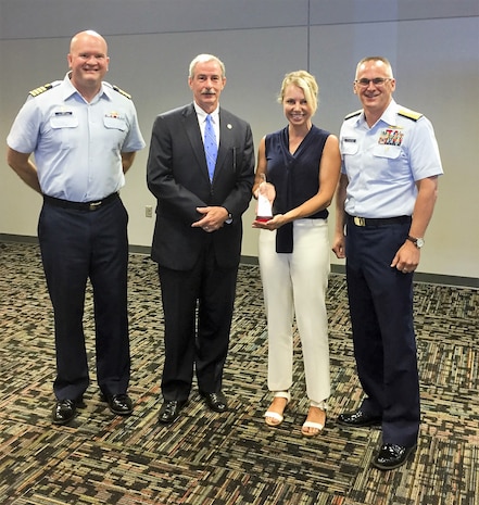 Capt. John Reed, left, Commanding Officer of Sector Charleston, Mark Keel, Chief of the South Carolina Law Enforcement Division (SLED), Heather Holmquest, President of the Maritime Association of South Carolina, and Rear Adm. John Nadeau, right, Assistant Commandant for Prevention Policy, stand together, Monday, July 9, 2018, during a recognition ceremony for the Charleston Area Maritime Security Committee (AMSC) at the International Longshoreman's Association building in Charleston, S.C.