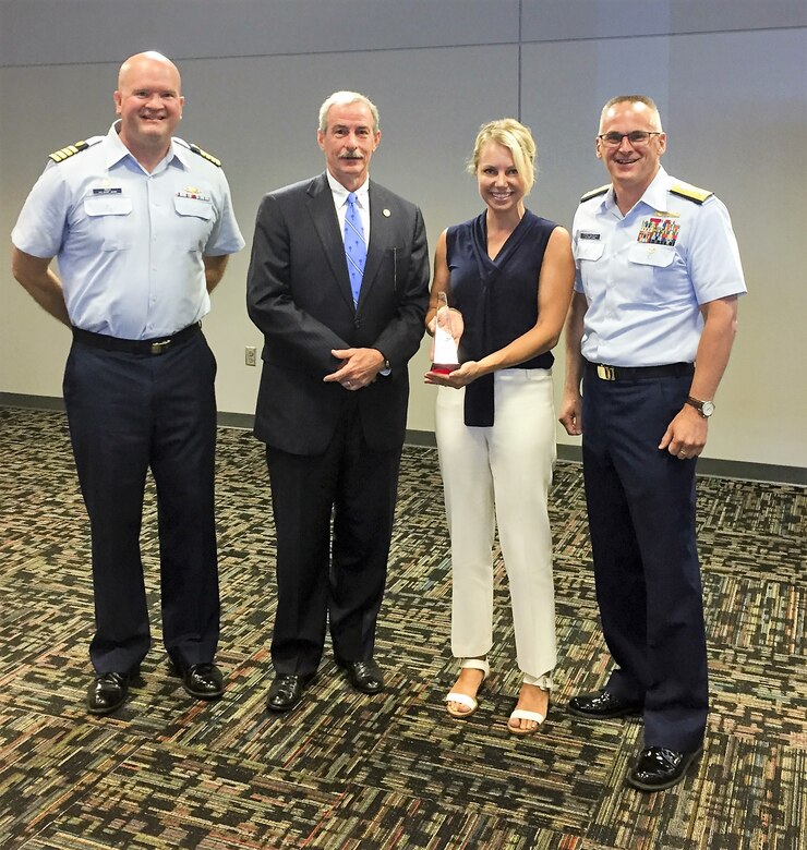 Capt. John Reed, left, Commanding Officer of Sector Charleston, Mark Keel, Chief of the South Carolina Law Enforcement Division (SLED), Heather Holmquest, President of the Maritime Association of South Carolina, and Rear Adm. John Nadeau, right, Assistant Commandant for Prevention Policy, stand together, Monday, July 9, 2018, during a recognition ceremony for the Charleston Area Maritime Security Committee (AMSC) at the International Longshoreman's Association building in Charleston, S.C.