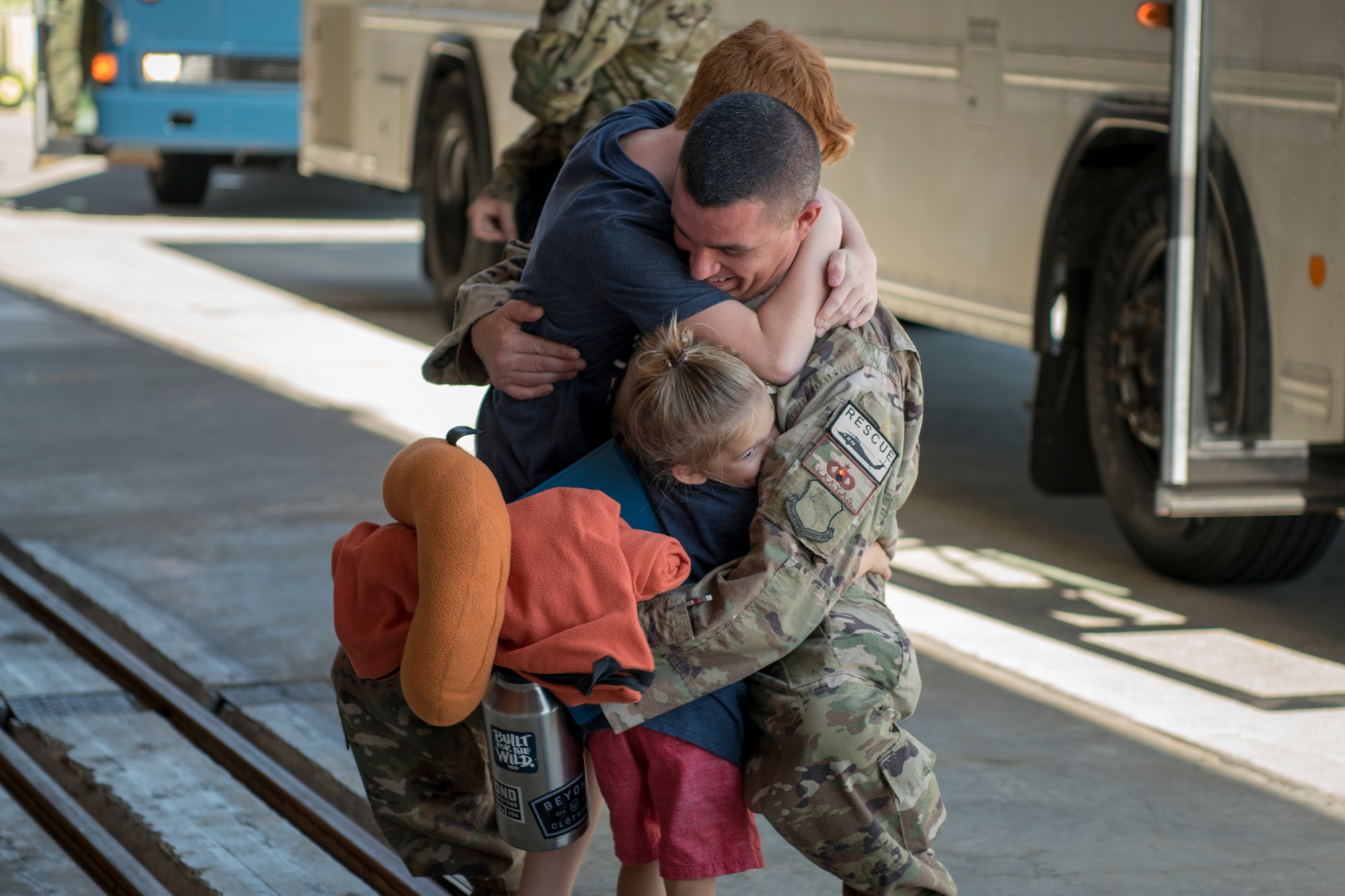 An Airman reunites with his family during the 41st Rescue Squadron’s (RQS) redeployment ceremony, July 10, 2018, at Moody Air Force Base, Ga. While deployed, the 41st RQS and the 41st Helicopter Maintenance Unit provided combat search and rescue capabilities and maintenance operations in support of Combined Joint Task Force-Horn of Africa. (U.S. Air Force photo by Airman Taryn Butler)