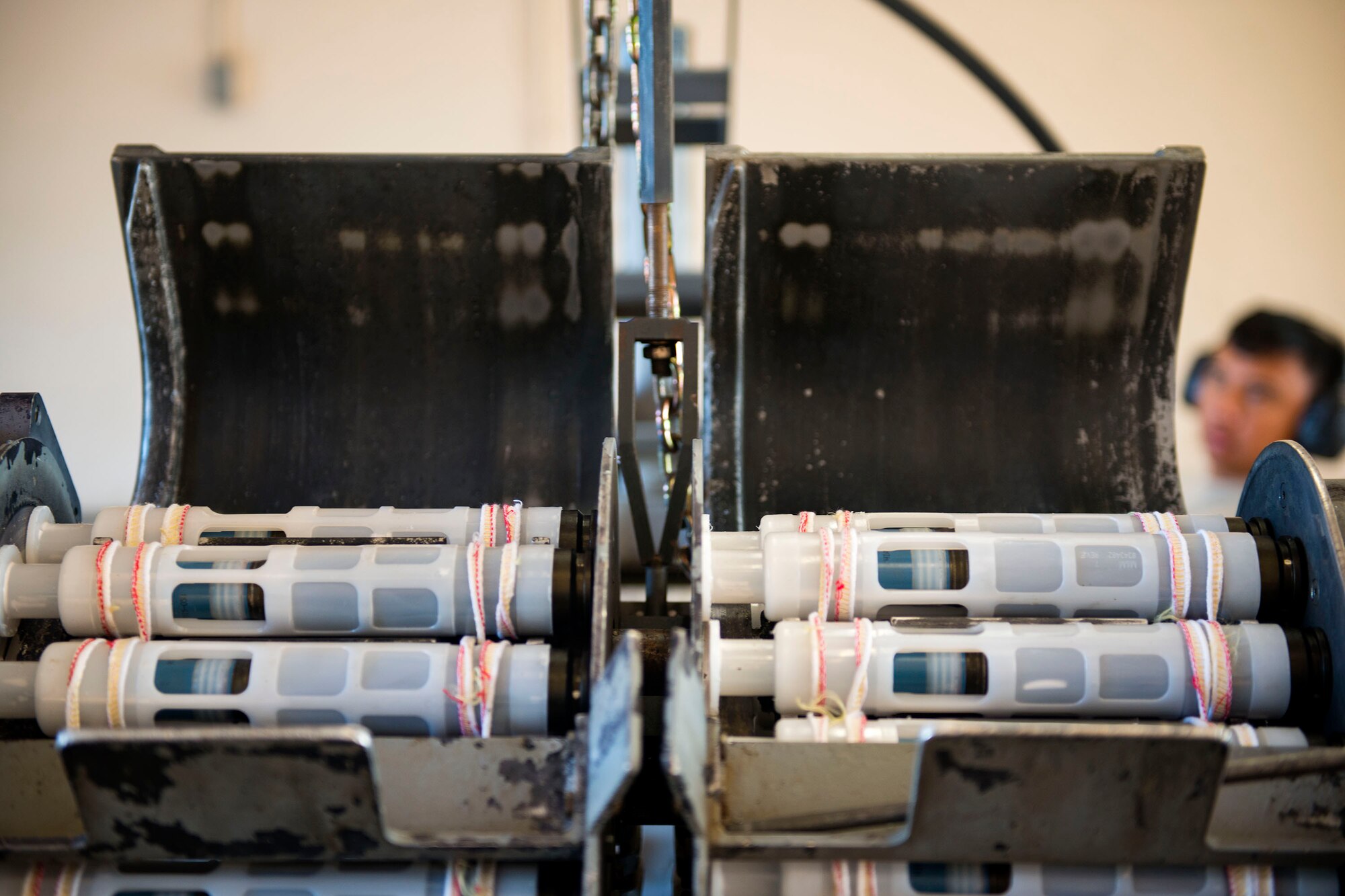 Linked tube carriers rest in a GFU-7 rail system during a 30mm rounds processing, July 11, 2018, at Moody Air Force Base, Ga. This total force integration training with the 23d and 476th Maintenance Squadron allowed Airmen to work together to identify more ways to efficiently and safely conduct their mission. The munitions flight ensures the A-10C Thunderbolt IIs are armed with 30mm rounds to make sure they are able to continue their mission while at home station and deployed. (U.S. Air Force photo by Airman 1st Class Erick Requadt)