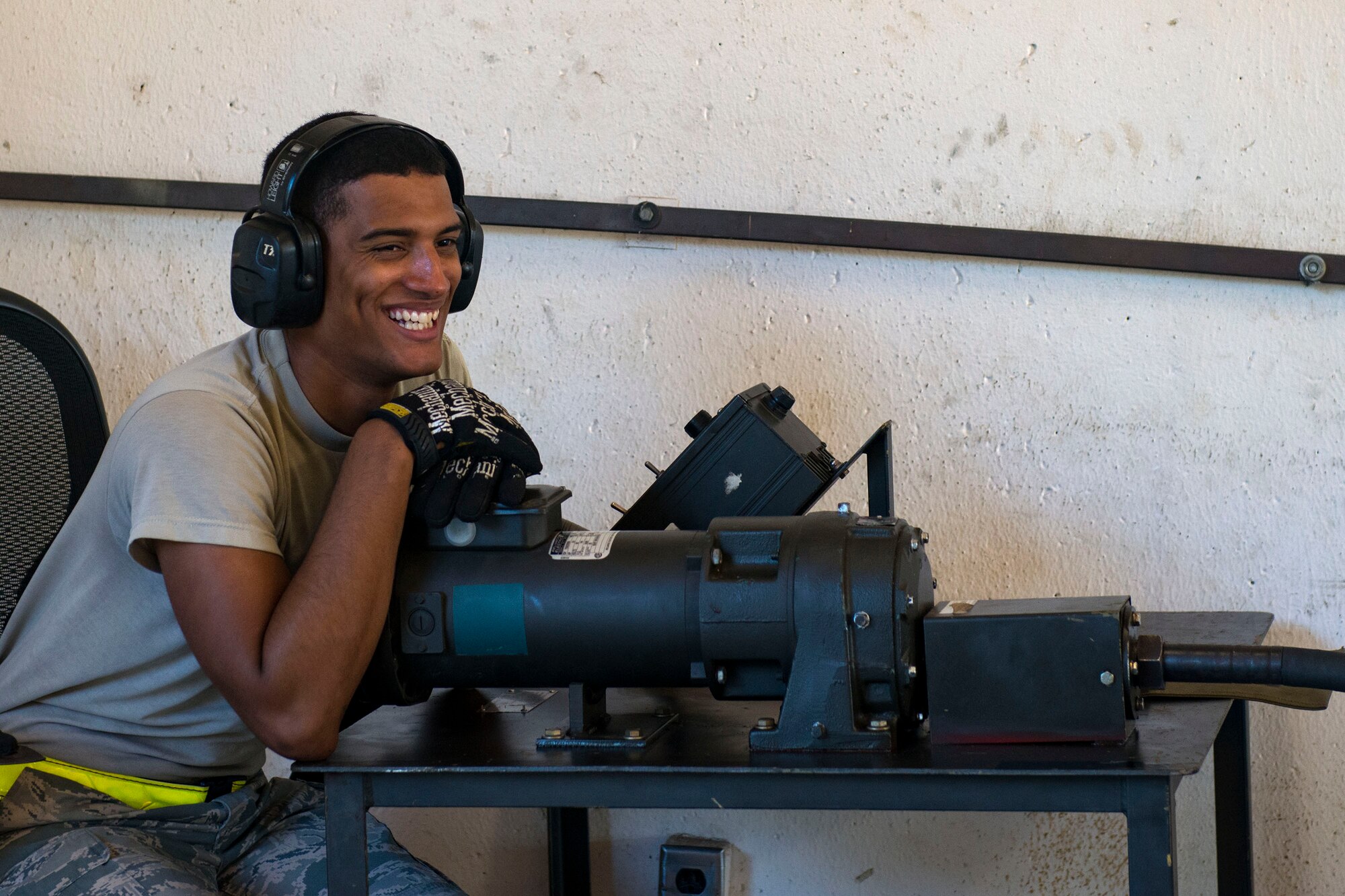 Senior Airman Skyler Hall, 23d Maintenance Squadron (MXS) crew chief, smiles during a 30mm rounds processing, July 11, 2018, at Moody Air Force Base, Ga. This total force integration training with the 23d and 476th MXS allowed Airmen to work together to identify more ways to efficiently and safely conduct their mission. The munitions flight ensures the A-10C Thunderbolt IIs are armed with 30mm rounds to make sure they are able to continue their mission while at home station and deployed. (U.S. Air Force photo by Airman 1st Class Erick Requadt)