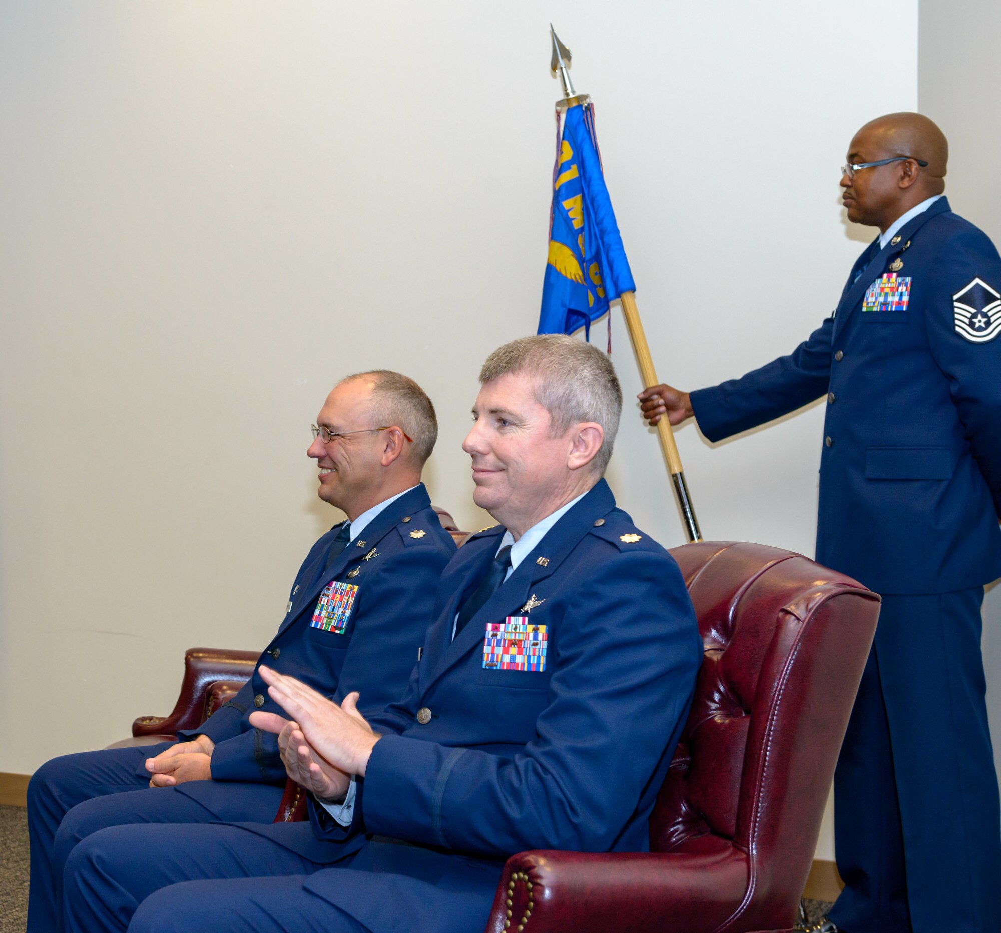 U.S. Air Force Lt. Col. Jerry Hambright, outgoing 81st Communications Squadron commander, and Maj. Jon Drummond, incoming 81st CS commander, participate in the 81st CS change of command ceremony in the Roberts Consolidated Aircraft Maintenance Facility Auditorium at Keesler Air Force Base, Mississippi, June 28, 2018. The passing of the guidon is a ceremonial symbol of exchanging command from one commander to another. (U.S. Air Force photo by Andre’ Askew)