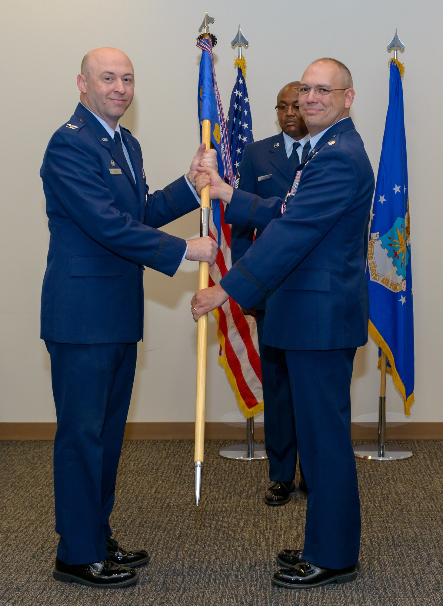 U.S. Air Force Col. Danny Davis, 81st Mission Support Group commander, takes the 81st Communications Squadron guidon from Lt. Col. Jerry Hambright, outgoing 81st CS commander, during the 81st CS change of command ceremony in the Roberts Consolidated Aircraft Maintenance Facility Auditorium at Keesler Air Force Base, Mississippi, June 28, 2018. The passing of the guidon is a ceremonial symbol of exchanging command from one commander to another. (U.S. Air Force photo by Andre’ Askew)