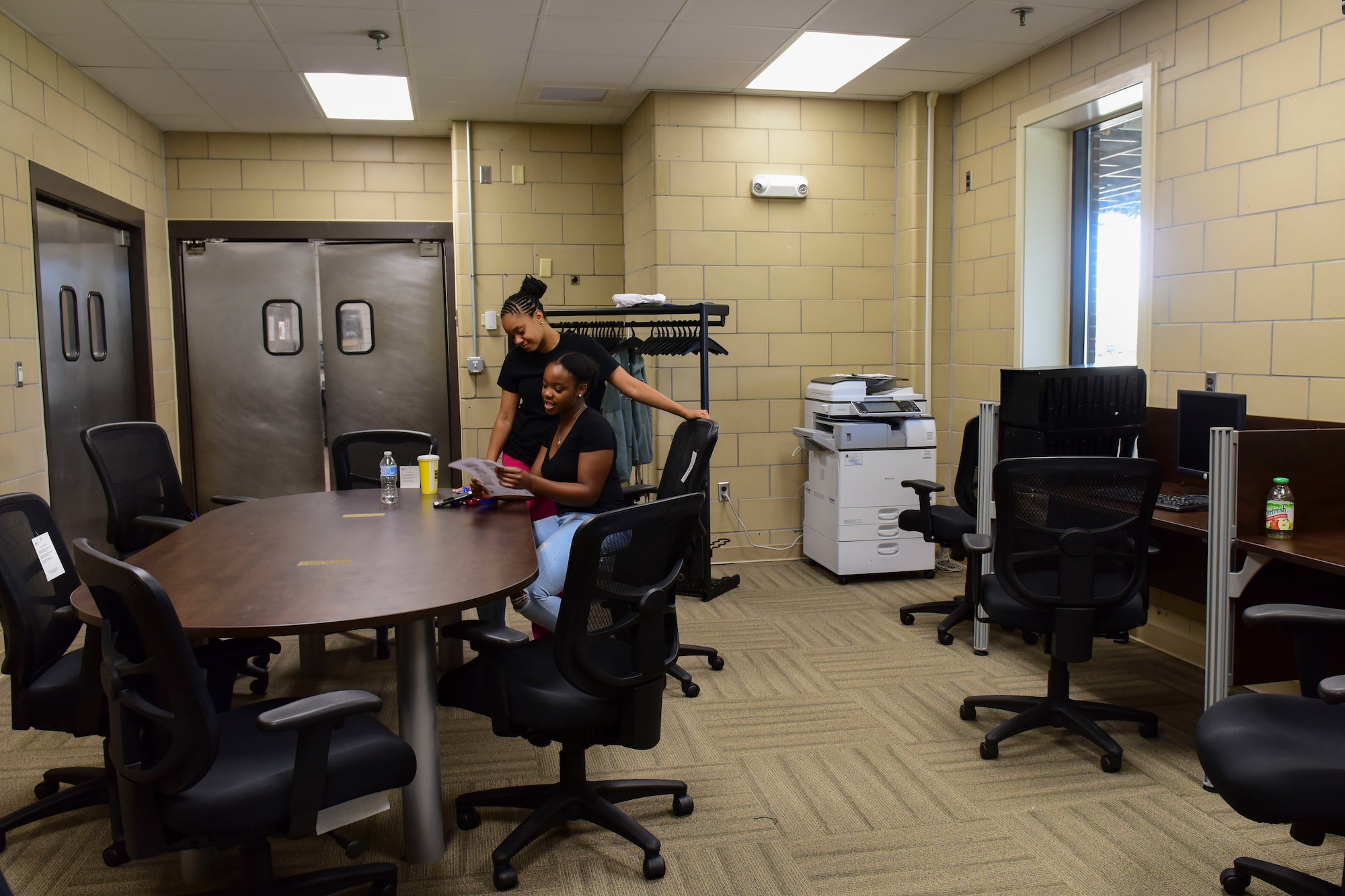 U.S. Air Force Airmen 1st Class Dyamon Abrahams, (left), and Chelsi Knott, 633rd Force Support Squadron services journeyman, read paperwork in the Crossbow Dining Facility at Joint Base Langley-Eustis, Virginia, July 10, 2018. Dining facility renovations included a new office with an upgraded heating, ventilation and air conditioning system and computer work stations for training. (U.S. Air Force photo by Airman 1st Class Monica Roybal)