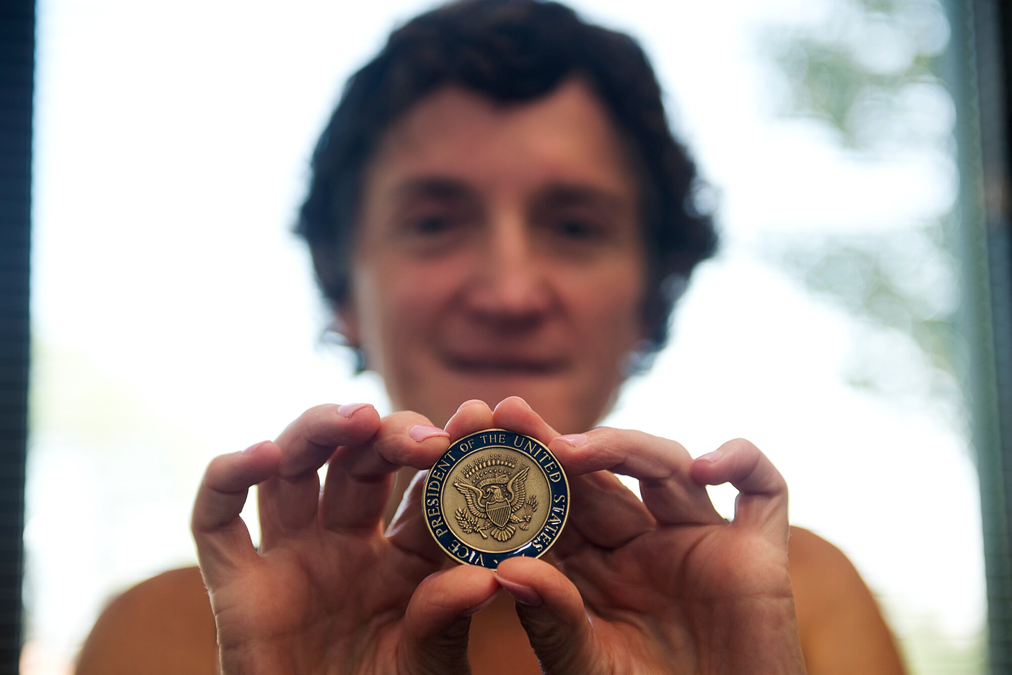 Linda Ambard, a violence prevention integrator assigned to the 509th Bomb Wing at Whiteman Air Force Base, Missouri, holds her Vice Presidential commemorative coin July 10, 2018.