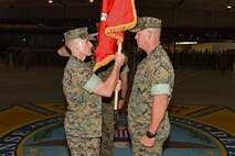 U.S. Marine Corps Lt. Col. Earl Patterson, Marine Corps Detachment Goodfellow incoming commanding officer, takes the guideon from Maj. Andrew Armstrong, Marine Corps Detachment Goodfellow outgoing commanding officer, during the Marine Corps Detachment Goodfellow Change of Command at the Louis F. Garland Department of Defense Fire Academy on Goodfellow Air Force Base, Texas, July 10, 2018. While holding the guideon, Patterson received verbal orders to lead the Marine Corps Detachment Goodfellow. (U.S. Air Force photo by Staff Sgt. Joshua Edwards/Released)