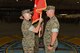 U.S. Marine Corps Lt. Col. Earl Patterson, Marine Corps Detachment Goodfellow incoming commanding officer, takes the guideon from Maj. Andrew Armstrong, Marine Corps Detachment Goodfellow outgoing commanding officer, during the Marine Corps Detachment Goodfellow Change of Command at the Louis F. Garland Department of Defense Fire Academy on Goodfellow Air Force Base, Texas, July 10, 2018. While holding the guideon, Patterson received verbal orders to lead the Marine Corps Detachment Goodfellow. (U.S. Air Force photo by Staff Sgt. Joshua Edwards/Released)