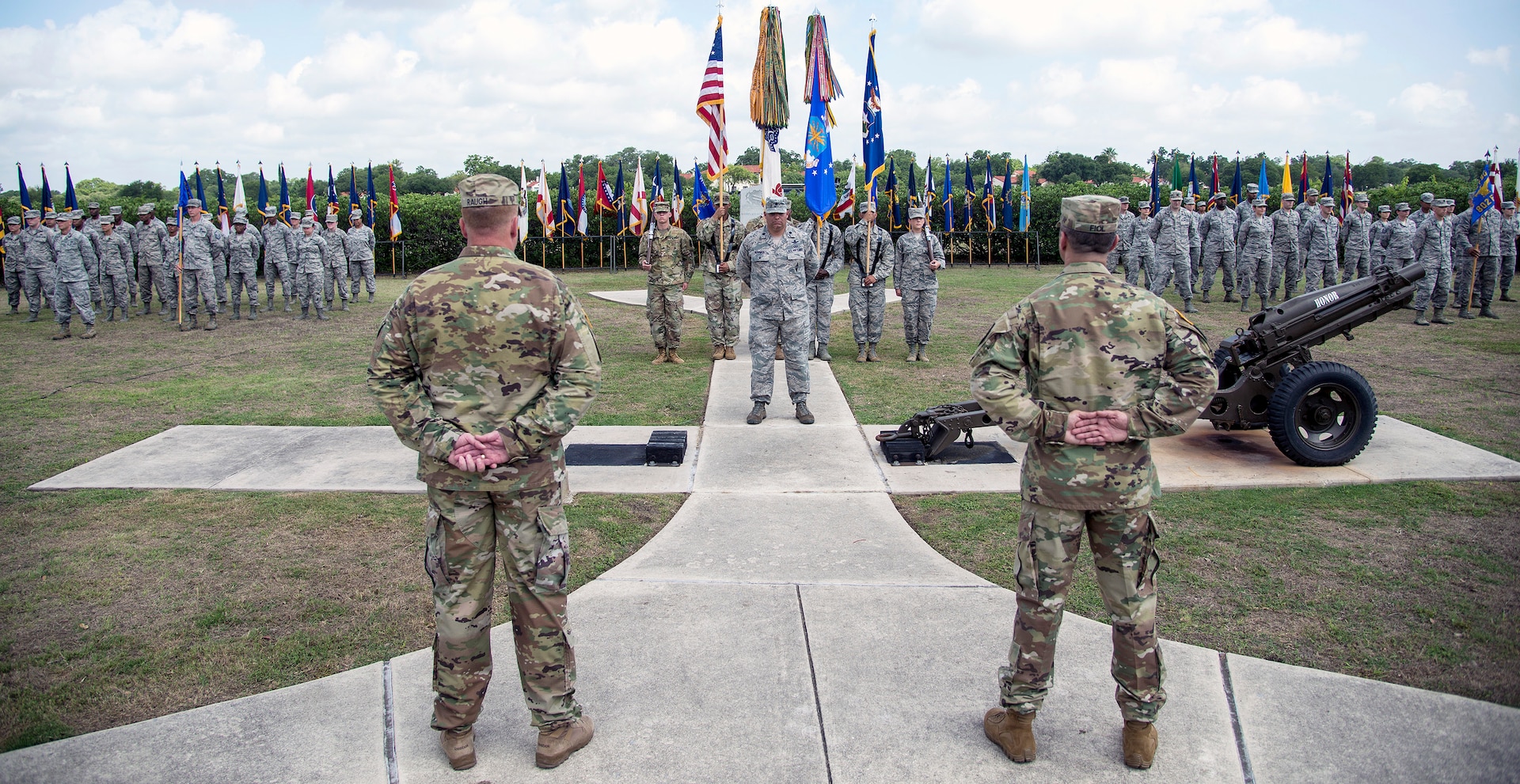 Col. David L. Raugh (left) and Col. Samuel E. Fiol (right) stand at parade rest during the 502nd Force Support Group change of command ceremony held at the JBSA-Fort Sam Houston base flagpole July 11. Raugh turned over command of the group to Fiol during the ceremony.