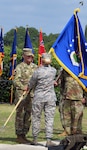 Col. Samuel E. Fiol (left) receives the 502nd Force Support Group colors from Brig. Gen. Laura L. Lenderman, 502nd Air Base Wing and Joint Base San Antonio commander, during a change of command ceremony held at the JBSA-Fort Sam Houston base flagpole July 11, where he took over for outgoing commander Col. David L. Raugh.