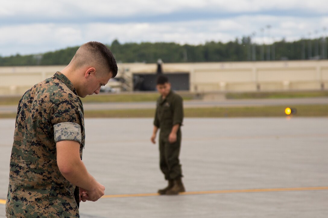 Lance Cpl. Raymond Boule, an airframe maintenance technician assigned to Marine Attack Squadron (VMA) 214, conducts a Foreign Object Debris (FOD) walk in preparation for the arrival of their AV-8B Harriers at Joint Base Elmendorf-Richardson, Alaska, June 27, 2018. VMA-214 will participate in the 2018 Arctic Thunder Air Show with a flyby, hover demonstration, and a static display. (U.S. Marine Corps photo by Lance Cpl. Sabrina Candiaflores)