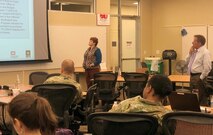 Colleen O’Keefe, Huntsville Center contracting director, and Chip Marin, Huntsville Center’s program director, provide information to Soldiers attending a workshop for military contracting professionals June 27 in Huntsville Alabama.