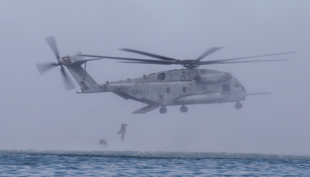 U.S. Marines with 1st Marine Reconnaissance Battalion and Canadian soldiers with the Royal 22e Régiment jump out of a CH-53E Super Stallion helicopter during helocast training as part of Rim of the Pacific (RIMPAC) exercise off the coast of Marine Corps Base Camp Pendleton, California, July 9, 2018. Helocasting is an airborne technique used by small unit, reconnaissance forces to insert into a military area of operations or maritime insertion point. RIMPAC demonstrates the value of amphibious forces and provides high-value training for task-organized, highly capable Marine Air-Ground Task Forces enhancing the critical crisis response capability of U.S. forces and partners globally. Twenty-five nations, 46 ships, five submarines, about 200 aircraft and 25,000 personnel are participating in RIMPAC from June 27 to Aug. 2 in and around the Hawaiian Islands and Southern California.
