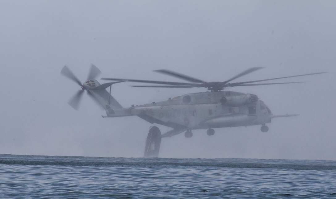U.S. Marines with 1st Reconnaissance Battalion and Canadian soldiers with the Royal 22e Régiment release a combat rubber raiding craft from a CH-53E Super Stallion helicopter during helocast training as part of Rim of the Pacific (RIMPAC) exercise off the coast of Marine Corps Base Camp Pendleton, California, July 9, 2018. Helocasting is an airborne technique used by small unit, reconnaissance forces to insert into a military area of operations or maritime insertion point. RIMPAC demonstrates the value of amphibious forces and provides high-value training for task-organized, highly capable Marine Air-Ground Task Forces enhancing the critical crisis response capability of U.S. forces and partners globally. Twenty-five nations, 46 ships, five submarines, about 200 aircraft and 25,000 personnel are participating in RIMPAC from June 27 to Aug. 2 in and around the Hawaiian Islands and Southern California.