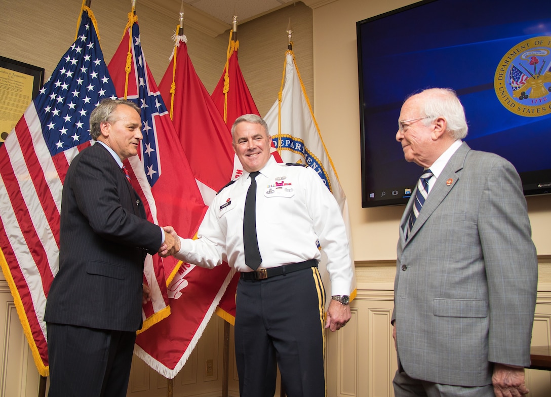 Mississippi River Commission President Maj. Gen. Richard Kaiser and Sam Angel, the MRC's longest standing member, congratulate James A. Reeder after his swearing in at the MRC headquarters in Vicksburg, Miss., July 11, 2018.
