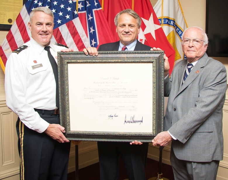Mississippi River Commission President Maj. Gen. Richard Kaiser and MRC member Sam Angel present an appointment letter to James A. Reeder at the MRC headquarters in Vicksburg, Miss., July 11, 2018.