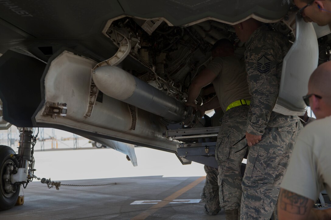 U.S. Airmen attached to the 4th Aircraft Maintenance Unit, Hill Air Force Base, Utah, load ordnance on to an F-35B Lightning II on MCAS Yuma Ariz., June 26, 2018. The exercise tested, for the first time, the interoperability of loading weapon systems between the services F-35's. The U.S. Air Force Operates with the F-35A Lightning II, while the U.S. Marine Corps Operates with the F-35B Lightning II. (U.S. Marine Corps photo by Lance Cpl. Joel Soriano)